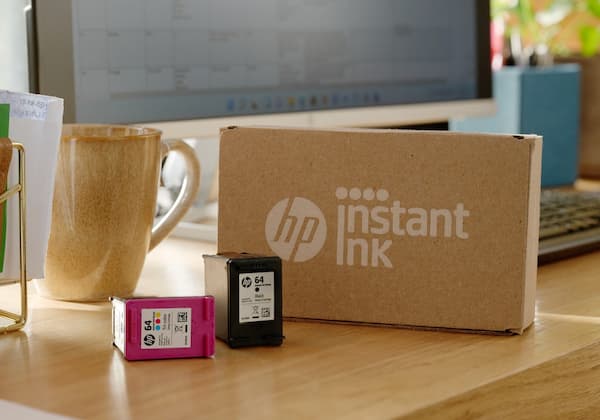 HP Instant Ink cartridges on desk