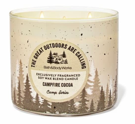Bath & Body Works 3-wick candle from the Camp Series labeled “Campfire Cocoa,” featuring a rustic design with tree silhouettes and speckled accents.